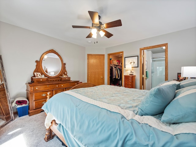 509 Kinkead Dr NW, Alexandria, MN 56308 - bedroom with light carpet, a walk in closet, a closet, a ceiling fan, and ensuite bath