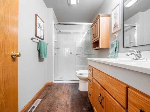 509 Kinkead Dr NW, Alexandria, MN 56308 - bathroom featuring toilet, a shower stall, wood finished floors, and vanity