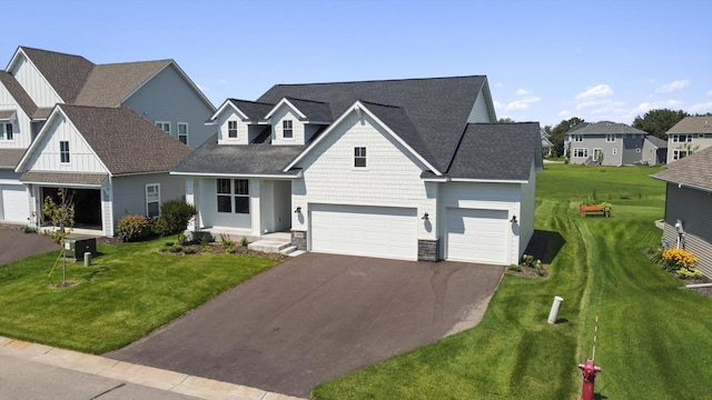 traditional-style house with asphalt driveway, a front yard, a residential view, and board and batten siding