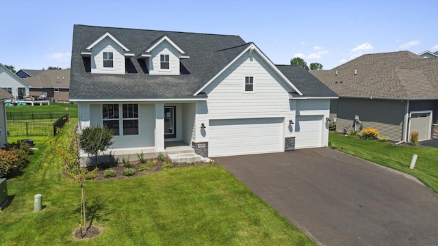 view of front of house with a porch, driveway, a shingled roof, a garage, and stone siding