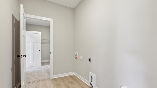 laundry area featuring electric dryer hookup, light wood-style floors, washer hookup, and baseboards
