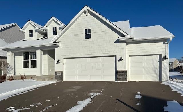view of front of home with asphalt driveway and a garage