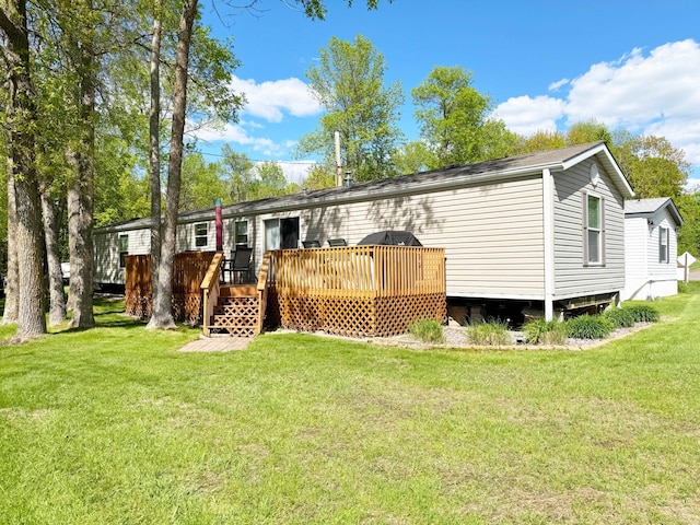 20429 326th Ave Unit 15, Isle, MN 56342 - back of property featuring a wooden deck and a lawn