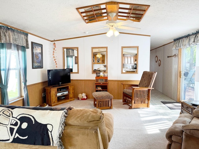 20429 326th Ave Unit 15, Isle, MN 56342 - living room with healthy amount of natural light, wainscoting, ornamental molding, ceiling fan, and a textured ceiling