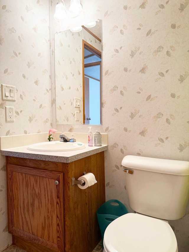 20429 326th Ave Unit 15, Isle, MN 56342 - bathroom with wallpapered walls, vanity, and toilet