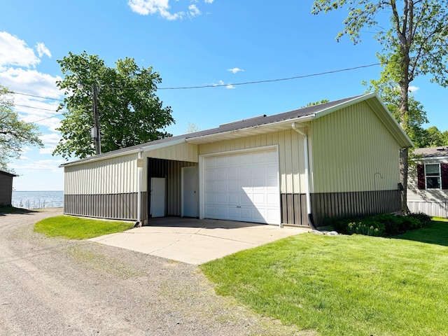 20429 326th Ave Unit 15, Isle, MN 56342 - garage featuring a garage, driveway, and a water view
