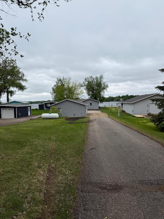14646 Tradewinds Rd, Lake Eunice Twp, MN 56511 - view of front facade featuring a garage and a front lawn