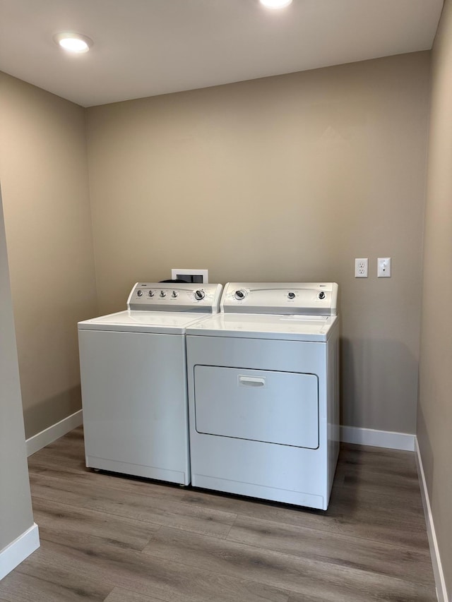 14646 Tradewinds Rd, Lake Eunice Twp, MN 56511 - washroom featuring independent washer and dryer, baseboards, and light wood-style floors