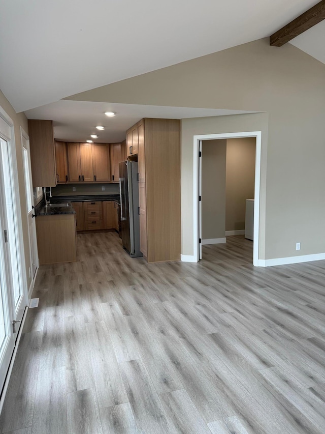 14646 Tradewinds Rd, Lake Eunice Twp, MN 56511 - kitchen with freestanding refrigerator, light wood finished floors, recessed lighting, dark countertops, and baseboards