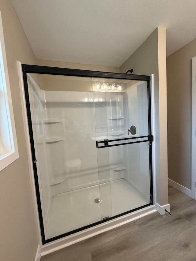 14646 Tradewinds Rd, Lake Eunice Twp, MN 56511 - bathroom with baseboards, wood finished floors, and a shower stall