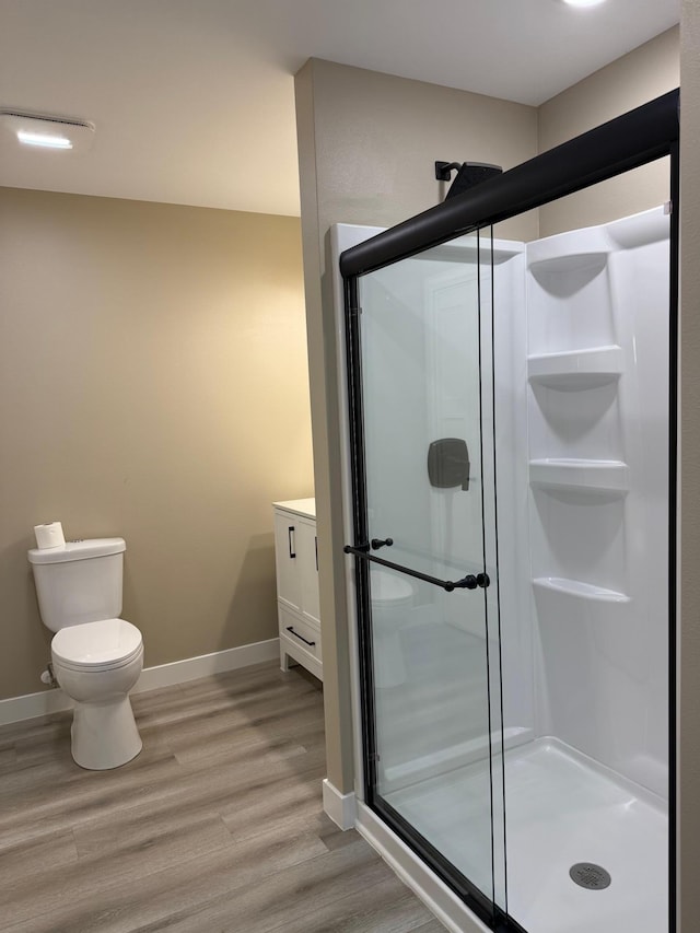 14646 Tradewinds Rd, Lake Eunice Twp, MN 56511 - full bathroom featuring a shower stall, wood finished floors, toilet, and baseboards