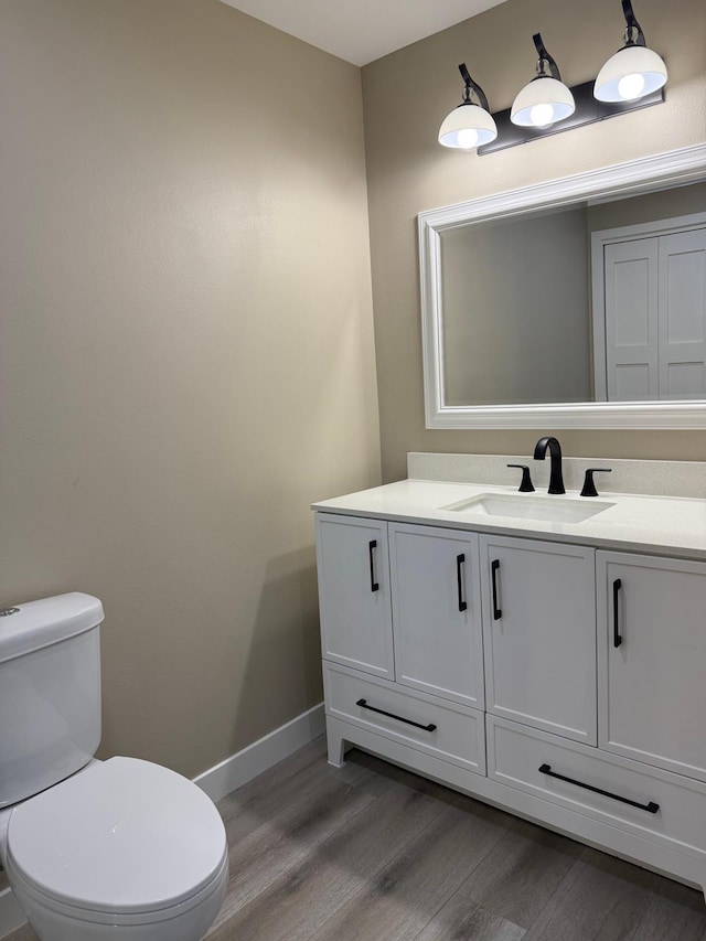 14646 Tradewinds Rd, Lake Eunice Twp, MN 56511 - bathroom featuring wood finished floors, baseboards, toilet, and vanity