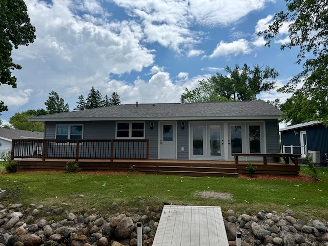 14646 Tradewinds Rd, Lake Eunice Twp, MN 56511 - view of front facade with a front yard, a deck, roof with shingles, and french doors