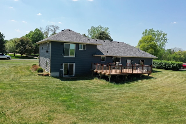 1803 214th Ave NE, East Bethel, MN 55011 - rear view of house with a wooden deck, a lawn, and roof with shingles