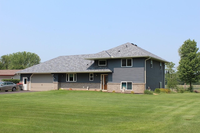 1803 214th Ave NE, East Bethel, MN 55011 - view of front of house with a garage, a front yard, asphalt driveway, and brick siding