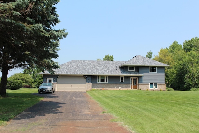 1803 214th Ave NE, East Bethel, MN 55011 - tri-level home featuring asphalt driveway, a garage, a front lawn, and brick siding