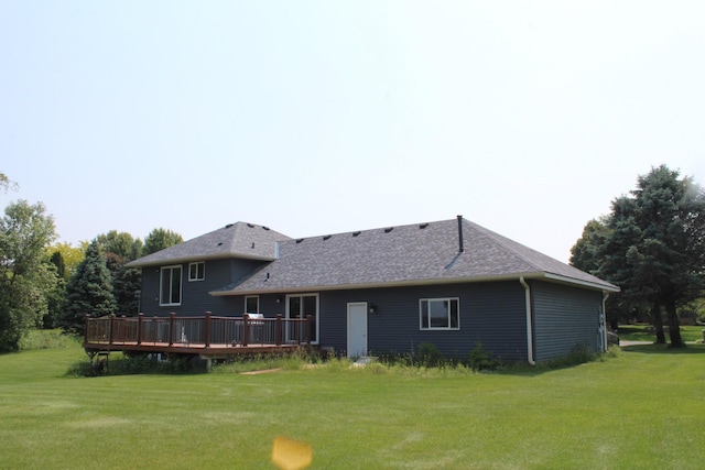 1803 214th Ave NE, East Bethel, MN 55011 - rear view of property featuring a deck, a lawn, and roof with shingles