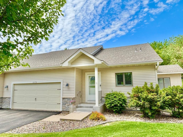 2075 Cardinal Gln N, Saint Paul, MN 55109 - view of front facade featuring an attached garage, a shingled roof, driveway, and stone siding