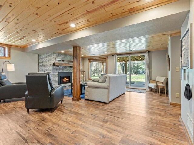 33527 Anderson Ct, Crosslake, MN 56442 - living room featuring wooden ceiling, a brick fireplace, light wood finished floors, recessed lighting, and baseboards
