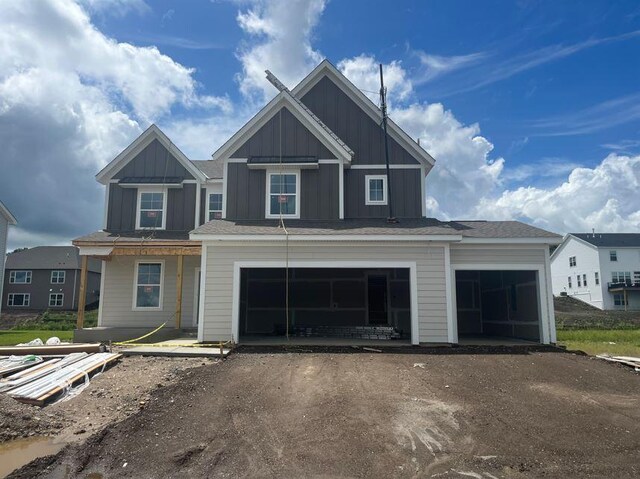 1165 Woods Creek Dr S, Delano, MN 55328 - view of front of property with board and batten siding and dirt driveway
