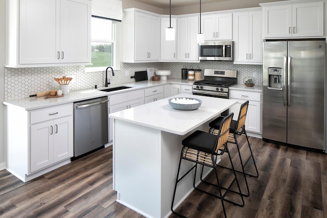1165 Woods Creek Dr S, Delano, MN 55328 - kitchen featuring appliances with stainless steel finishes, a breakfast bar area, dark wood-type flooring, and white cabinetry