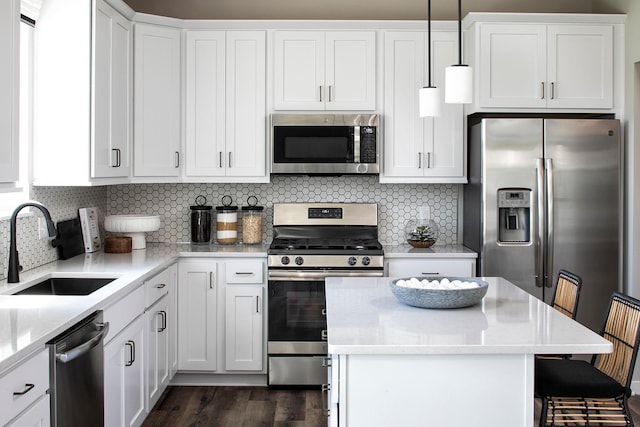 1165 Woods Creek Dr S, Delano, MN 55328 - kitchen with stainless steel appliances, a center island, white cabinets, and decorative backsplash