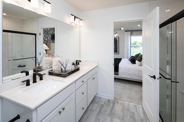 1165 Woods Creek Dr S, Delano, MN 55328 - ensuite bathroom with double vanity, a stall shower, and wood finished floors
