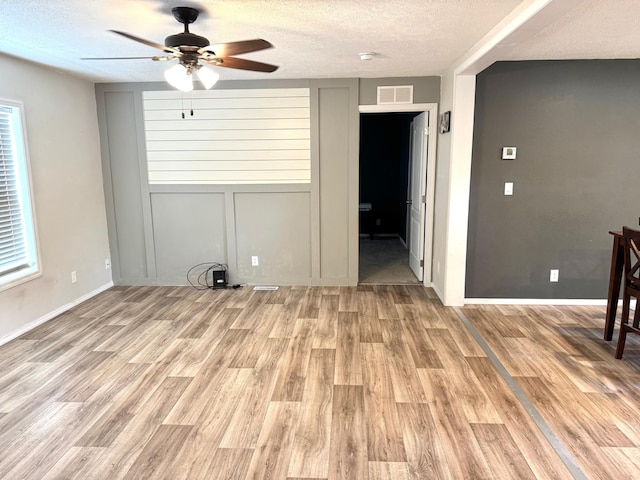 424 2nd St N, Greenbush, MN 56726 - unfurnished room featuring a ceiling fan, light wood finished floors, a textured ceiling, and baseboards