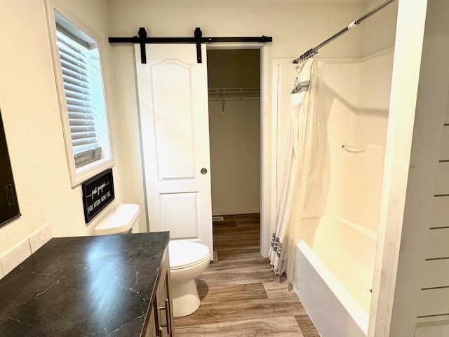 424 2nd St N, Greenbush, MN 56726 - bathroom featuring toilet, wood finished floors, vanity, and shower / bath combo with shower curtain