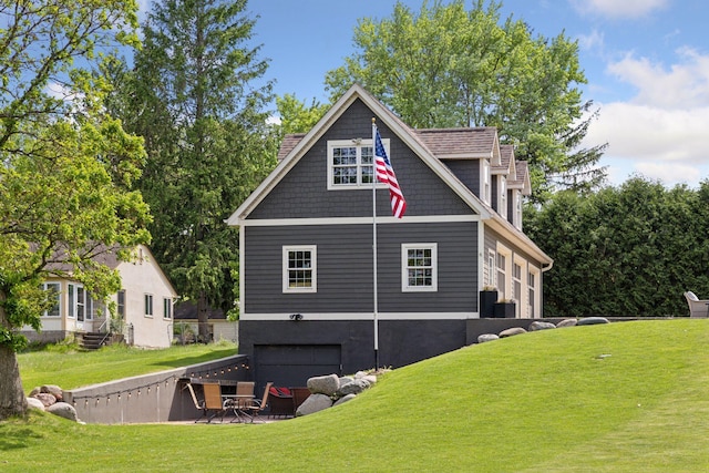 view of home's exterior with an attached garage and a lawn