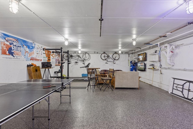 rec room featuring speckle patterned floor