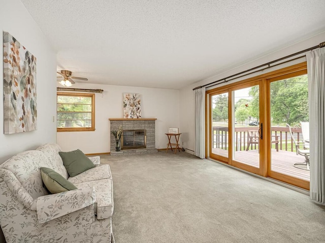 3401 Yukon Ave S, Saint Louis Park, MN 55426 - carpeted living room featuring a fireplace, a textured ceiling, baseboards, and a ceiling fan
