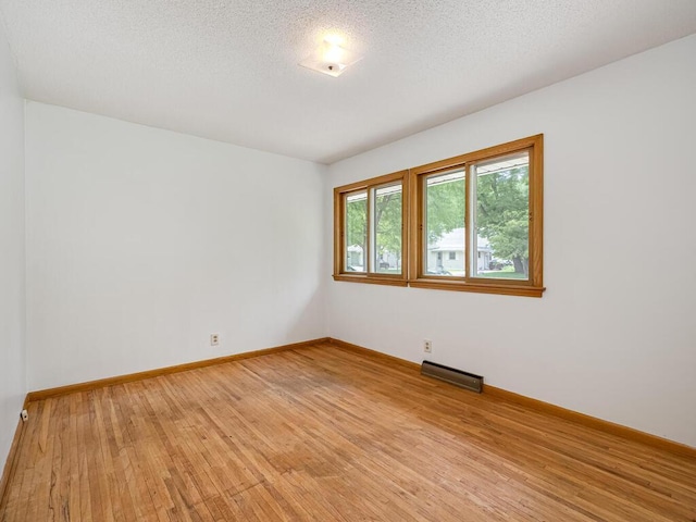 3401 Yukon Ave S, Saint Louis Park, MN 55426 - unfurnished room with light wood-style floors, baseboards, and a textured ceiling