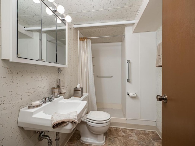 3401 Yukon Ave S, Saint Louis Park, MN 55426 - bathroom featuring a stall shower, a sink, toilet, and baseboards