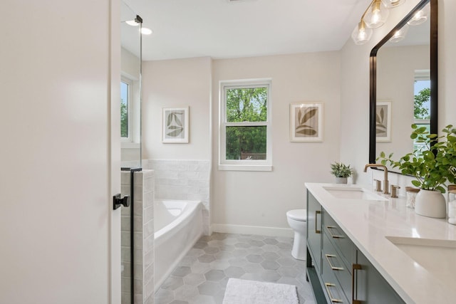 5350 41st Ave S, Minneapolis, MN 55417 - bathroom featuring double vanity, a garden tub, tile patterned floors, baseboards, and toilet