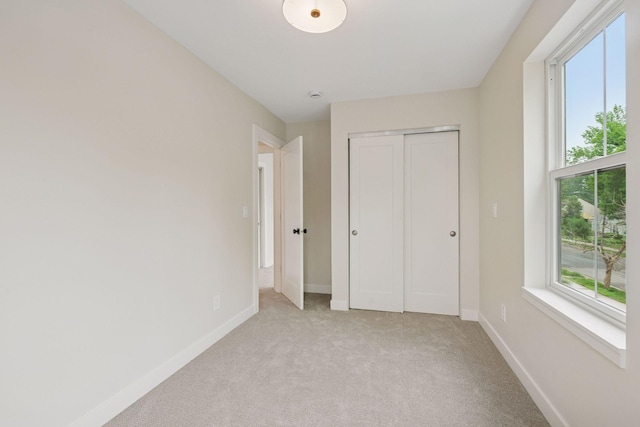 5350 41st Ave S, Minneapolis, MN 55417 - unfurnished bedroom featuring light colored carpet, baseboards, and a closet