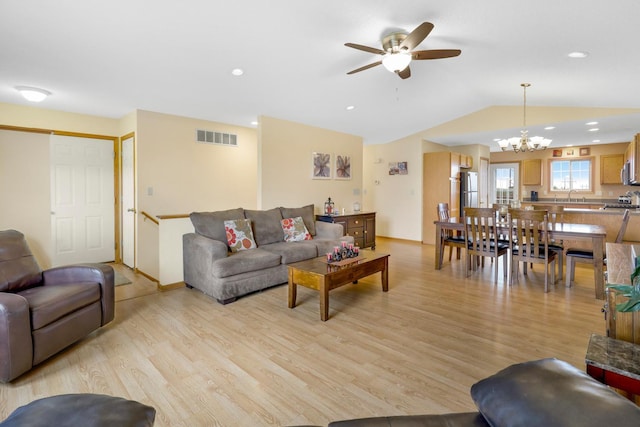 2245 198th St W, Faribault, MN 55021 - living area with light wood-type flooring, ceiling fan, vaulted ceiling, a chandelier, and recessed lighting