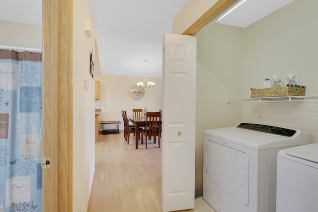 2245 198th St W, Faribault, MN 55021 - clothes washing area with independent washer and dryer, a chandelier, and light wood finished floors