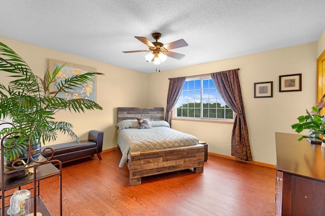 2245 198th St W, Faribault, MN 55021 - bedroom with light wood-style flooring, baseboards, a textured ceiling, and ceiling fan