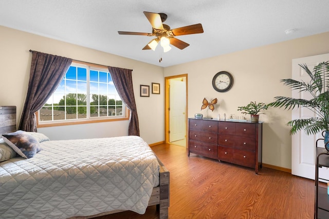 2245 198th St W, Faribault, MN 55021 - bedroom with wood finished floors, baseboards, and ceiling fan