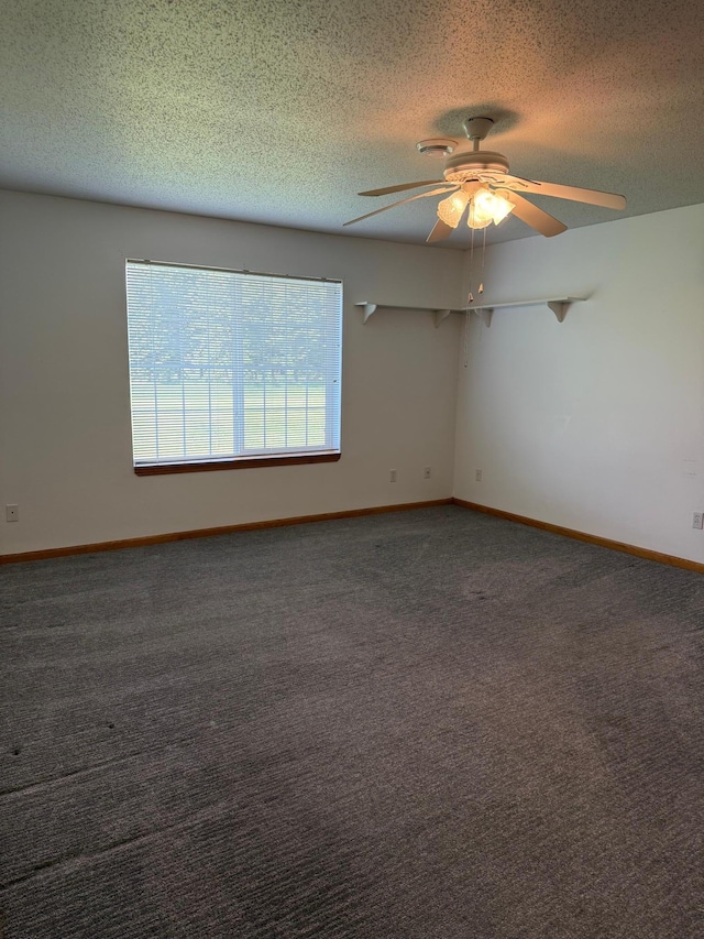 446 30th St N, Moorhead, MN 56560 - empty room featuring a textured ceiling, ceiling fan, carpet floors, and baseboards