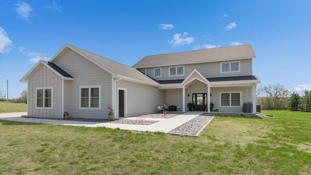 rear view of house with board and batten siding, a yard, central AC, and a porch