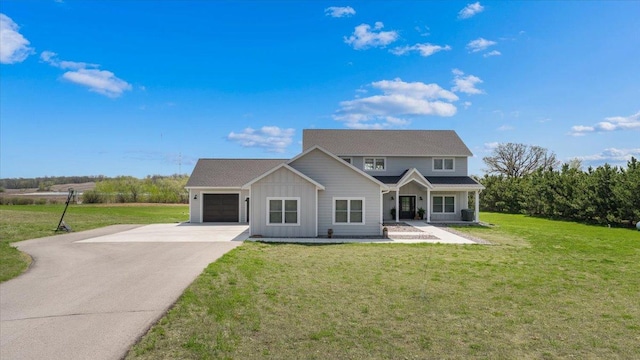 traditional home featuring board and batten siding, an attached garage, driveway, a front lawn, and covered porch