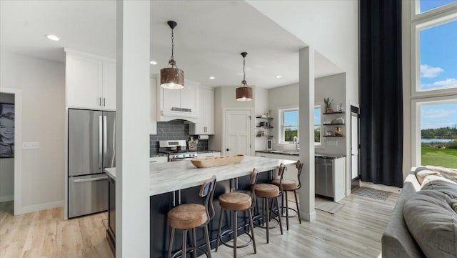 kitchen featuring appliances with stainless steel finishes, open shelves, white cabinetry, open floor plan, and tasteful backsplash