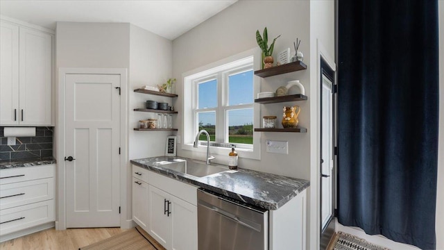 kitchen featuring a sink, open shelves, dishwasher, and white cabinetry