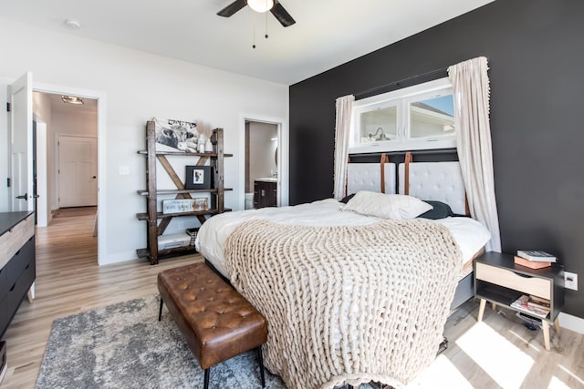 bedroom with light wood finished floors, ceiling fan, and baseboards