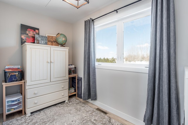 bedroom with wood finished floors and baseboards