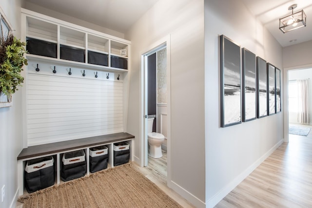 mudroom featuring light wood-style floors and baseboards