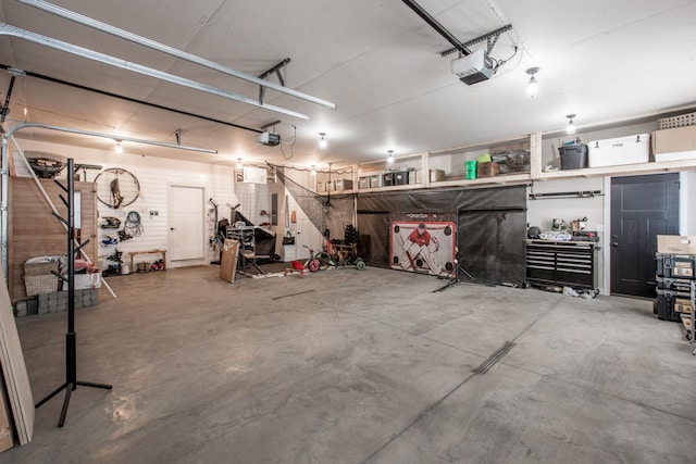 garage featuring a garage door opener and a workshop area