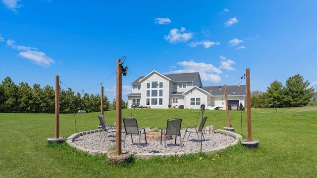 rear view of property with a fire pit and a lawn